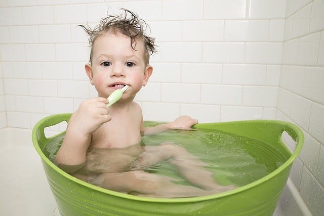 A toddler brushing their teeth