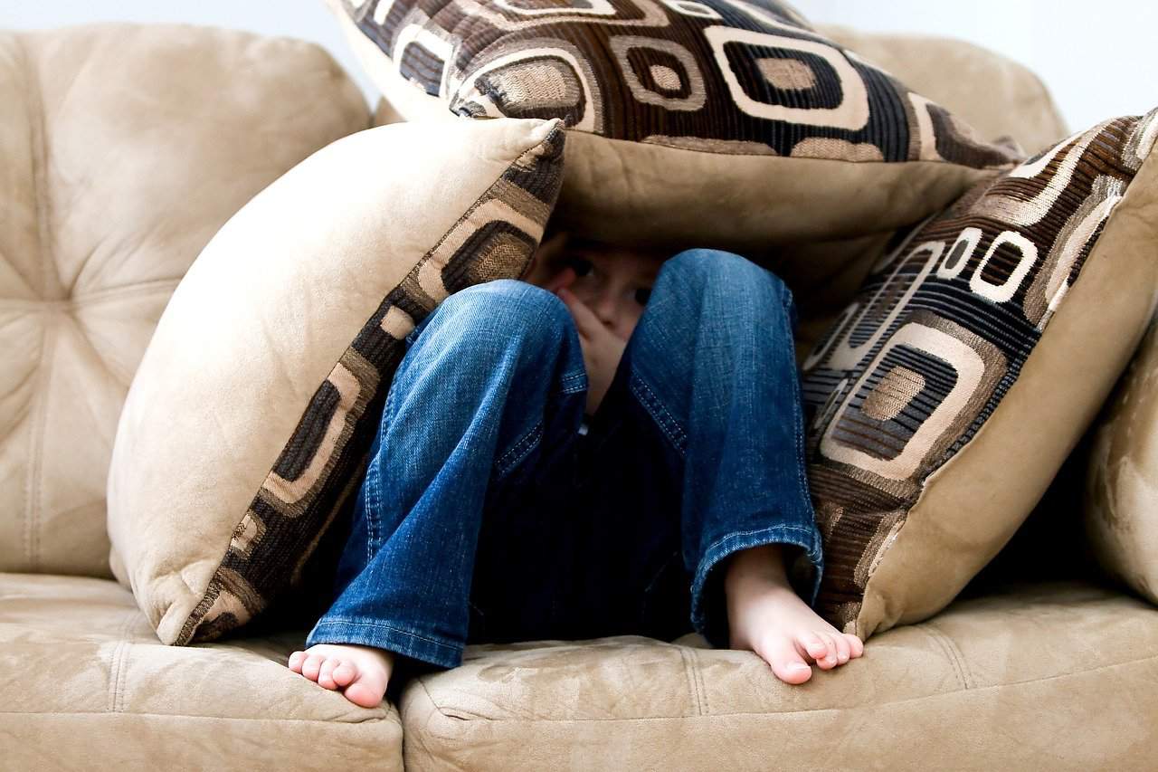 A boy alone on a couch