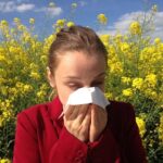 A lady with allergies sneezing